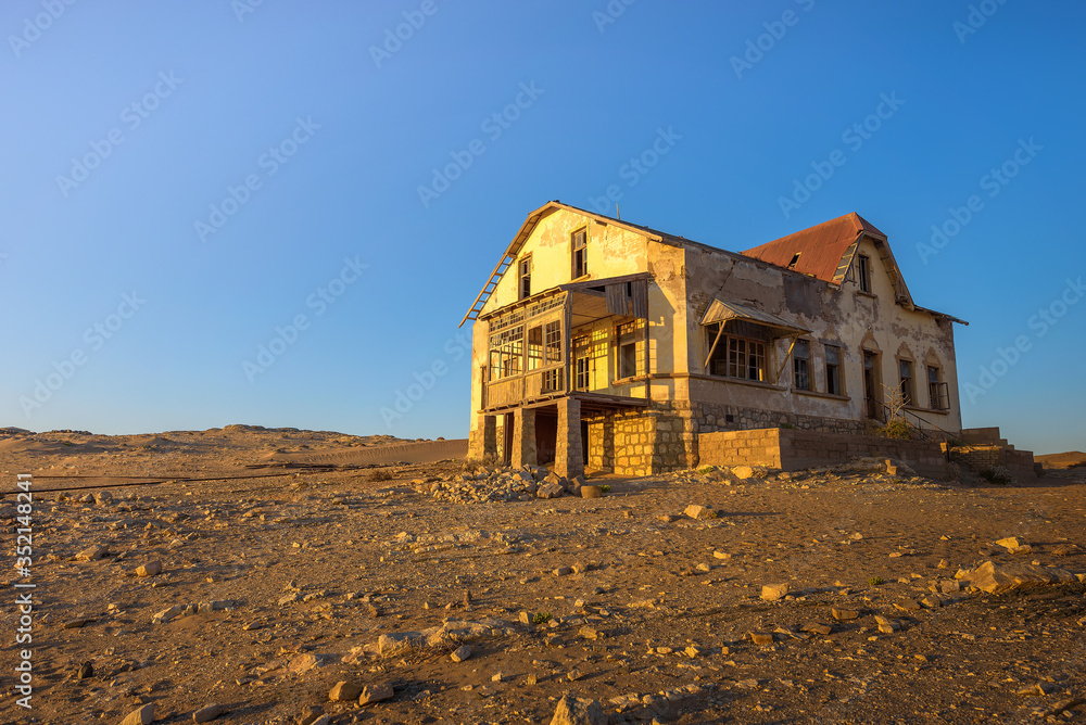 Sunrise above an abandoned house in Kolmanskop ghost town, Namibia Sunrise above an abandoned house in Kolmanskop ghost town, Namibia