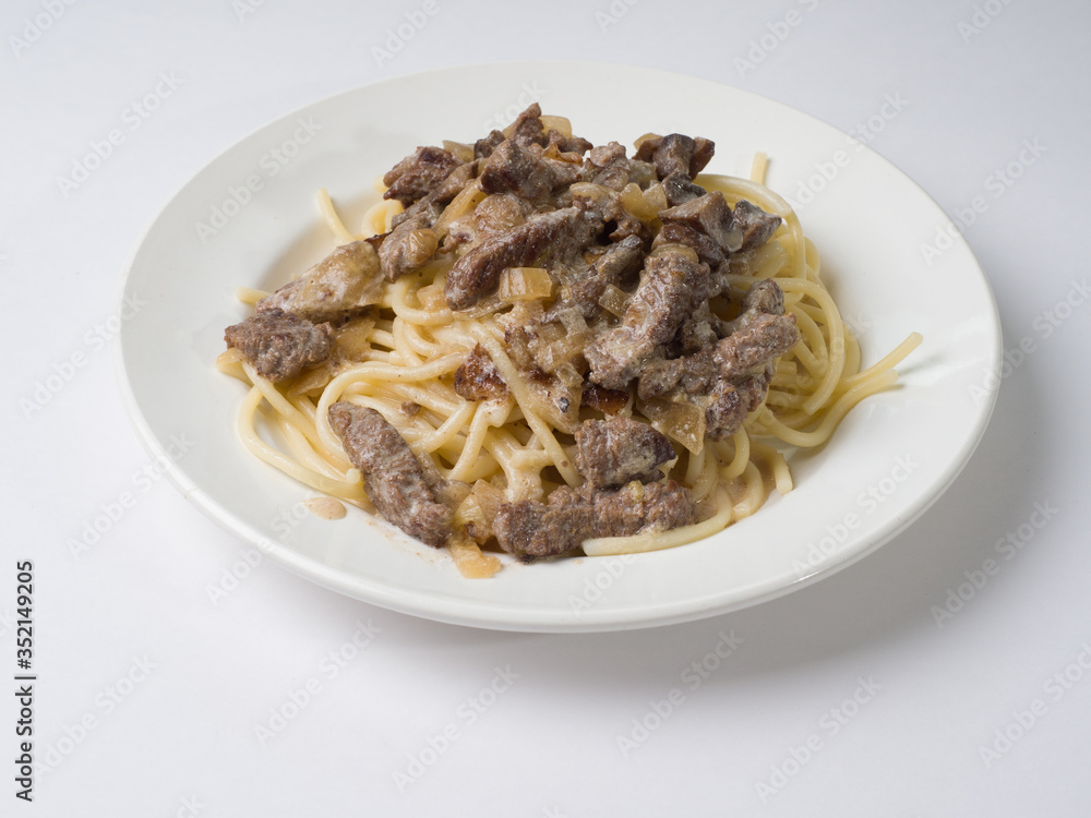 Beef stroganoff with pasta on a plate. Tasty healthy food