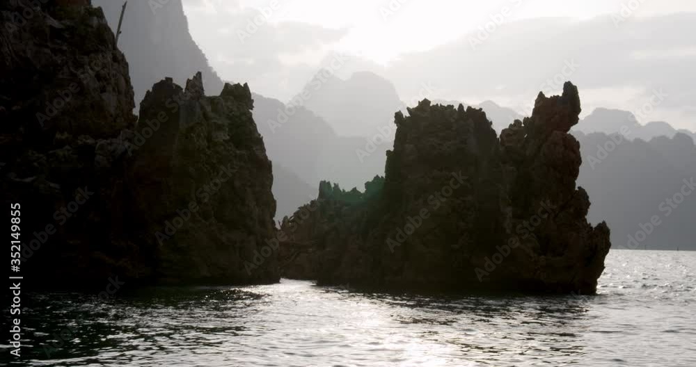 Lake, Rocky Cliffs and Mountain Silhouettes in Thailand Lake, Rocky Cliffs and Mountain Silhouettes in Thailand
