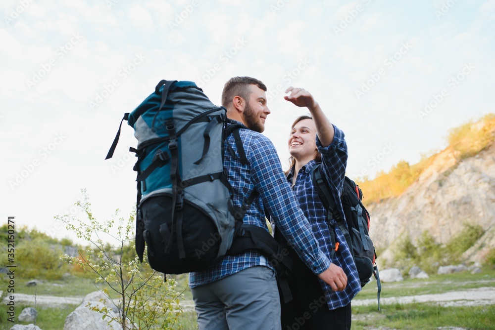 happy young couple hiking in mountain happy young couple hiking in mountain