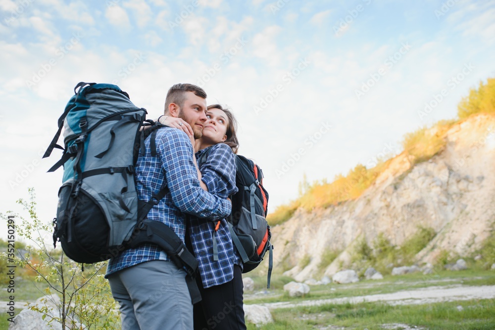 Happy romantic Couple Man and Woman Travelers with backpack holding hands mountaineering Travel Lifestyle and relationship love concept mountains landscape on background