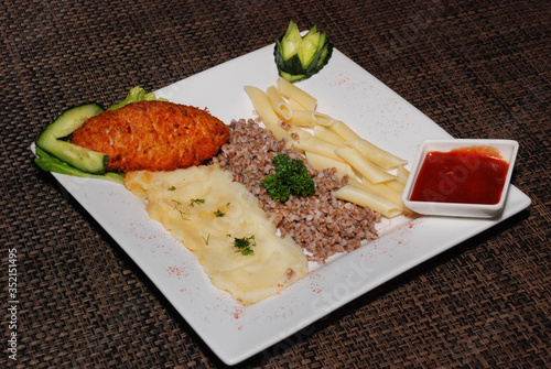 cutlet Kievsky and garnish on the white plate photo