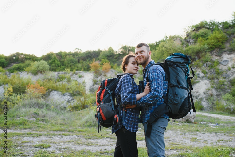 happy young couple hiking in mountain