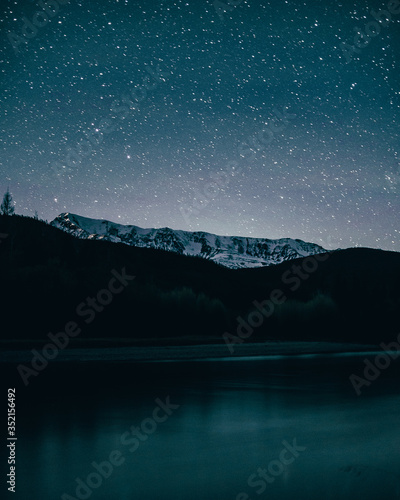 winter landscape with mountains. landscape with stars. man on the background of stars © Александр Хромов