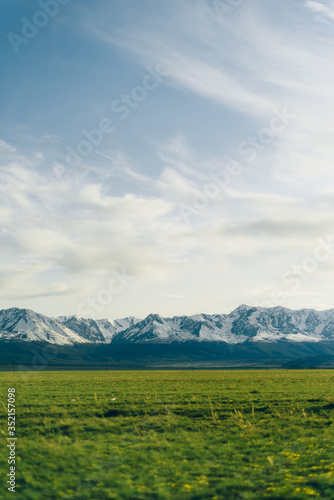 Snowy ridge. Altai mountains. Siberia. beautiful valley with green grass and mountains