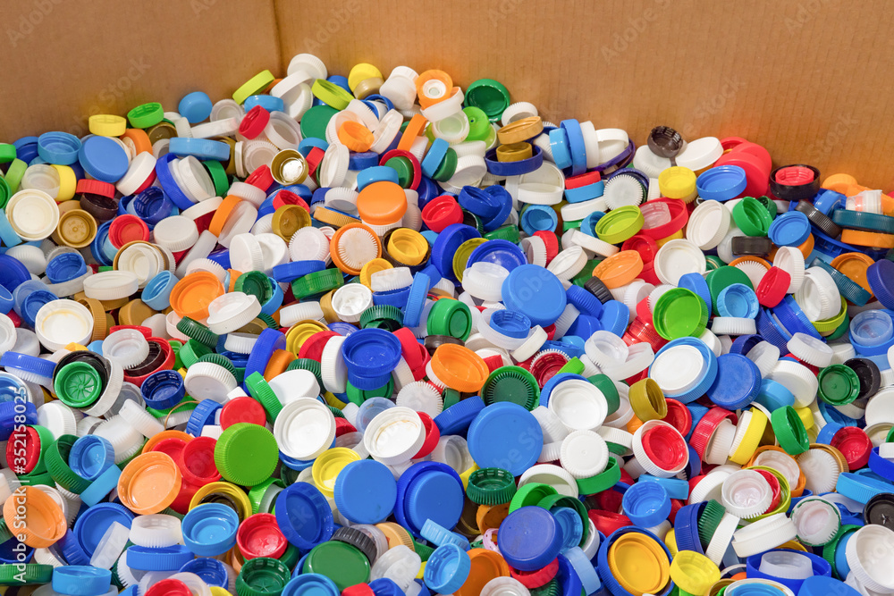 Plastic recycle. Sorting garbage. Waste recycling. Waste recycling plant. Colorful plastic bottle caps background. Colorful background of bottle caps. Recyclable waste concept. Material for processing Plastic recycle. Sorting garbage. Waste recycling. Waste recycling plant. Colorful plastic bottle caps background. Colorful background of bottle caps. Recyclable waste concept. Material for processing