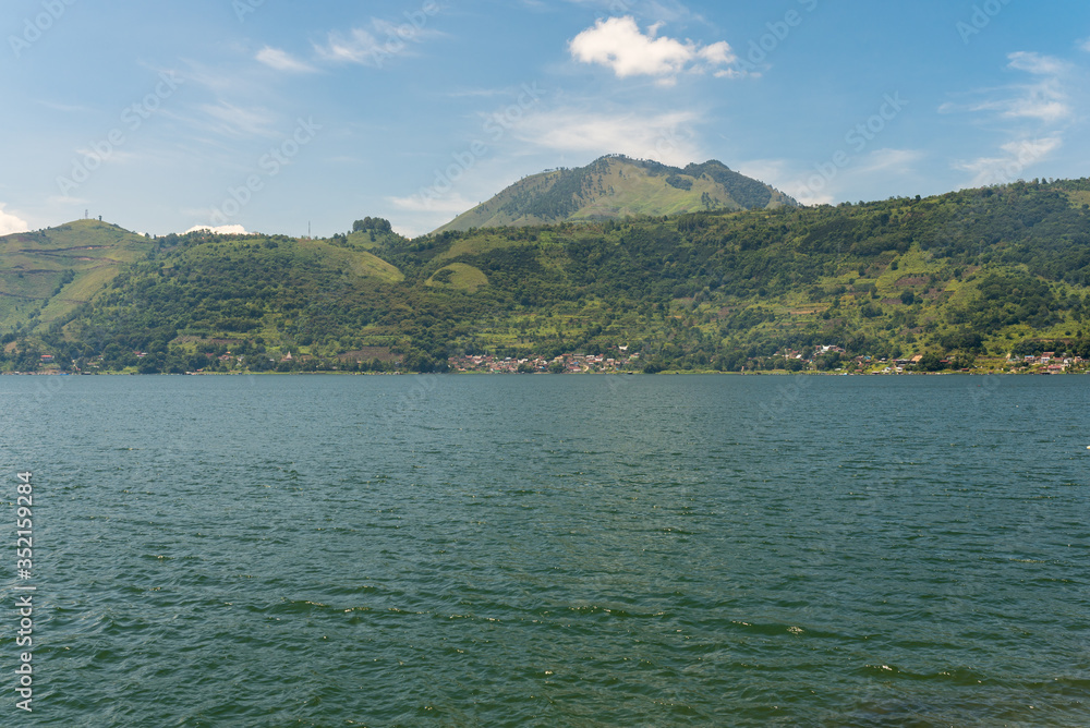 The volcano Pusuk Buhit, a 2000m high mountain at the Lake Toba, the largest volcanic lake in the world.In the Batak mythology the summit is called the birthplace of the Batak tribe The volcano Pusuk Buhit, a 2000m high mountain at the Lake Toba, the largest volcanic lake in the world.In the Batak mythology the summit is called the birthplace of the Batak tribe