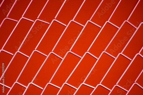 Top view of white plastic straws on red color background creating pattern