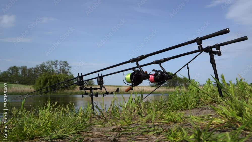 4K. Fishing on the shore with high-quality fishing gear, spinning, reliable reel and strong fishing line. A warm summer Sunny day. 4K. Fishing on the shore with high-quality fishing gear, spinning, reliable reel and strong fishing line. A warm summer Sunny day.