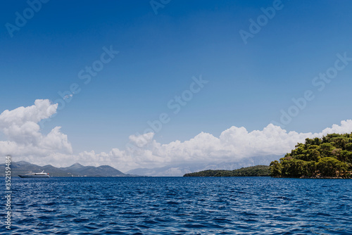 Greek Island viewed from the sea. Beautiful sea landscapes on Island in Greece. In distance is famous Scorpios island, from the left side is Lefkada island and from right is a part of gorgeous © andreiko