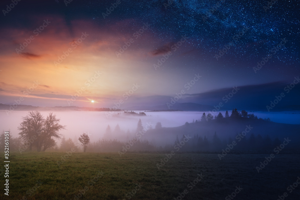 Obraz premium Day and night. Carpathian foggy mountain valley