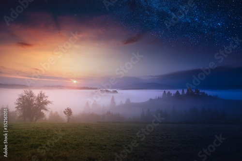 Day and night. Carpathian foggy mountain valley