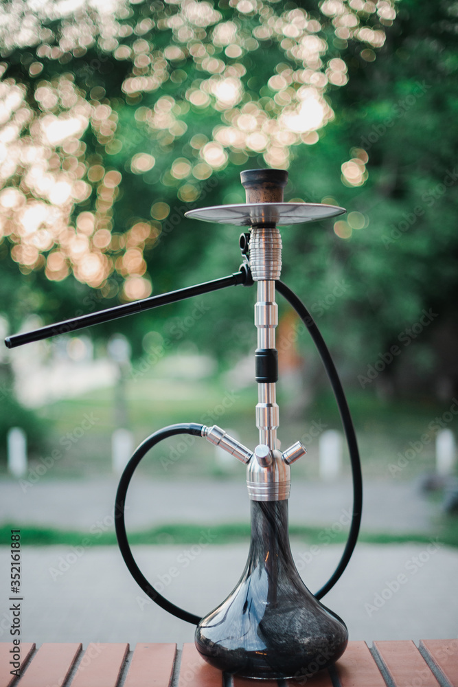 Metal hookah on a summer terrace with a blurred background Metal hookah on a summer terrace with a blurred background