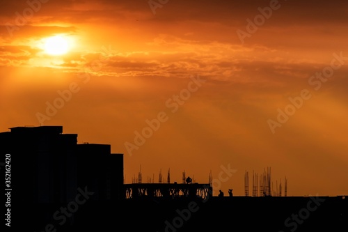 sunsets with workers in silhouette, Bangalore,  India