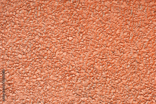 Concrete wall texture close up. Red art plaster.