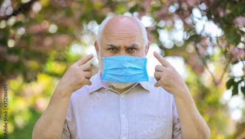 Elderly and other risk groups. Wear mask. Pandemic concept. Limit risk infection spreading. Senior man wearing face mask. Older people at highest risk from covid-19. Mask protecting from virus