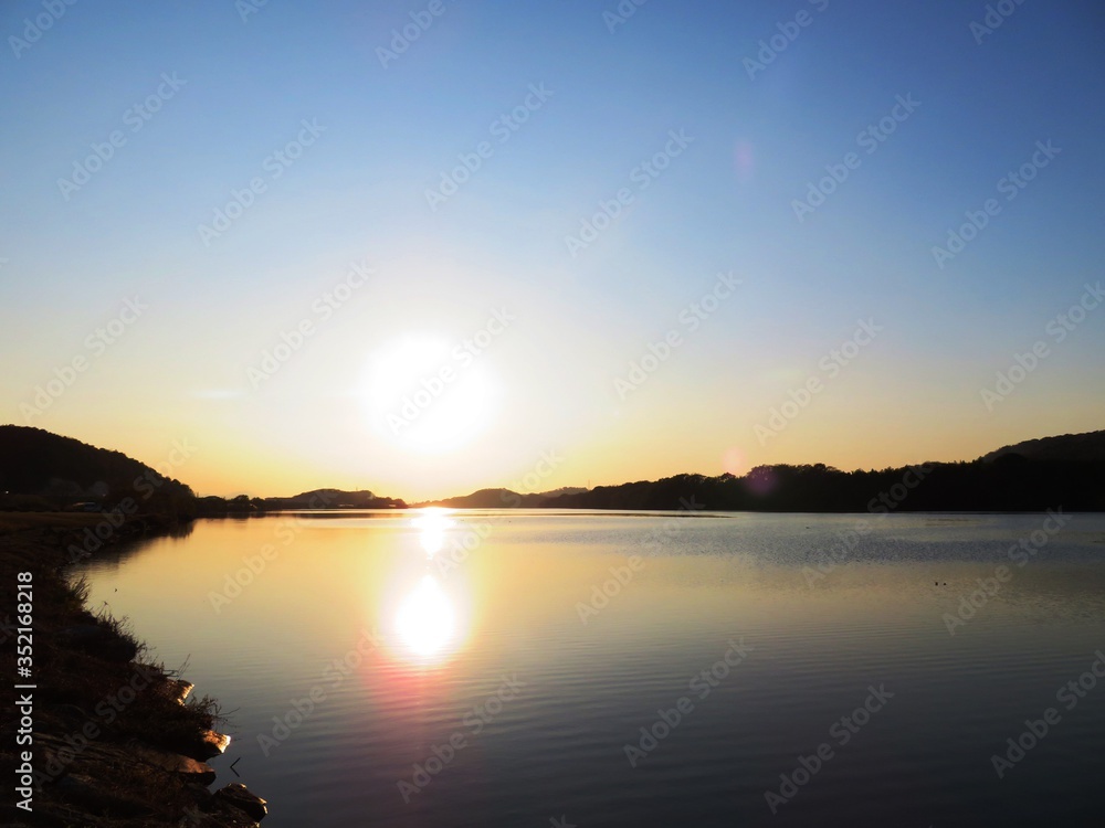 日本の田舎の風景　12月　河川敷の夕景グラデーション　日没と水鏡