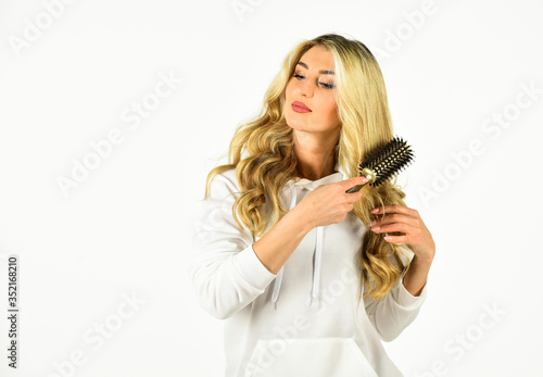 Long hair. Hair care. Hairdresser salon. Easy hairdo. Beauty supplies. Bristles perfectly untangle curly hair. Hot curling brush. Professional equipment. Pretty woman brushing hair isolated on white