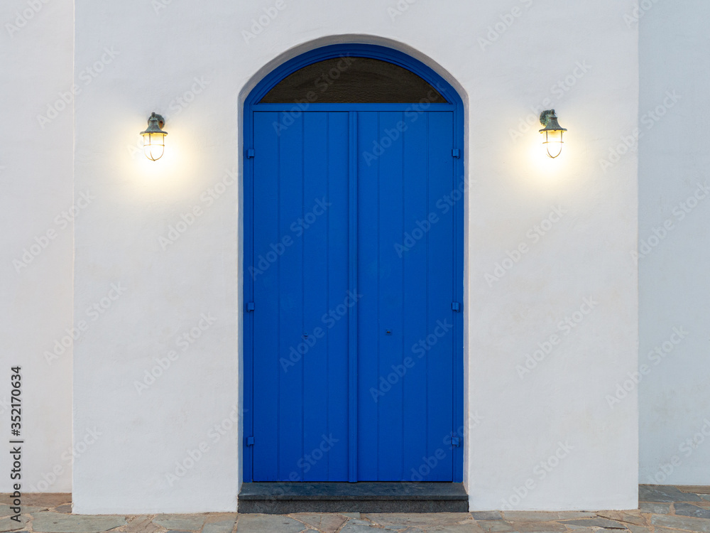 Image of old blue door with lights. Entrance to the Greek old church