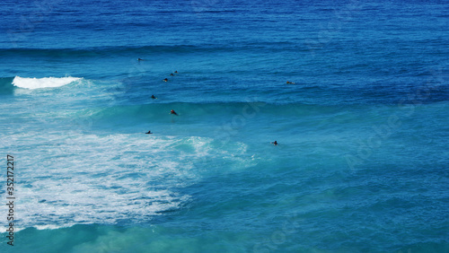 Surfers in Blue Wave Ocean
