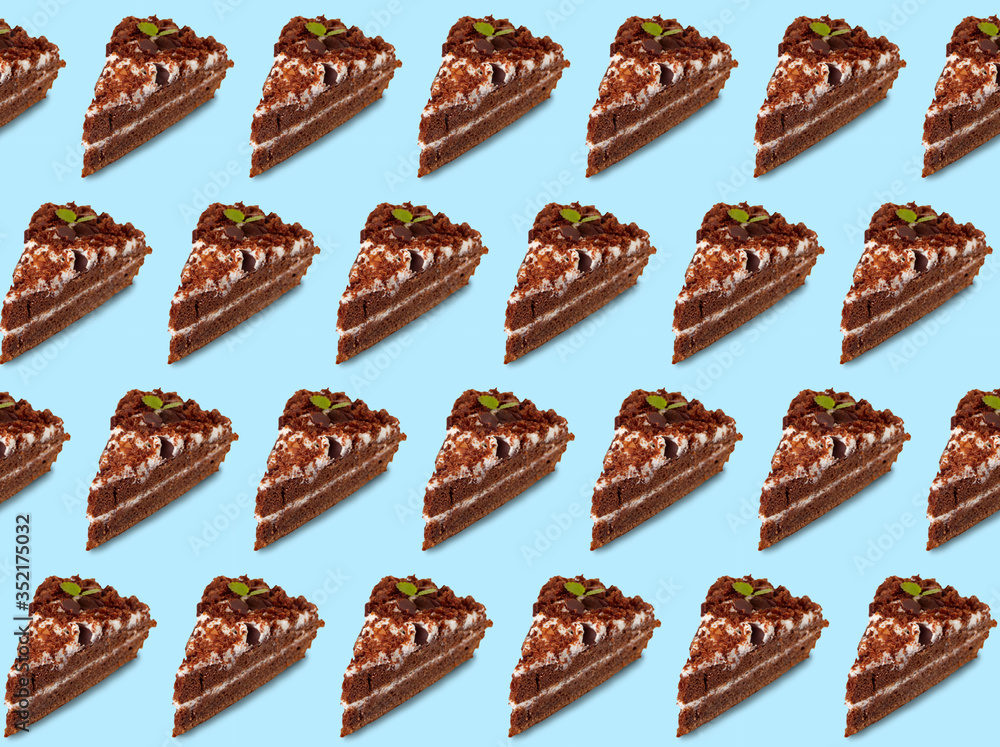 A slice of cake on a blue background. Culinary background. A slice of cake on a blue background. Culinary background.