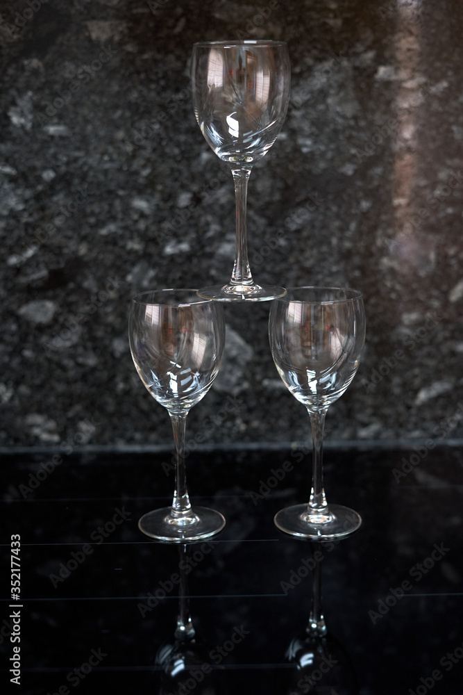 three glass cups on black background three glass cups on black background