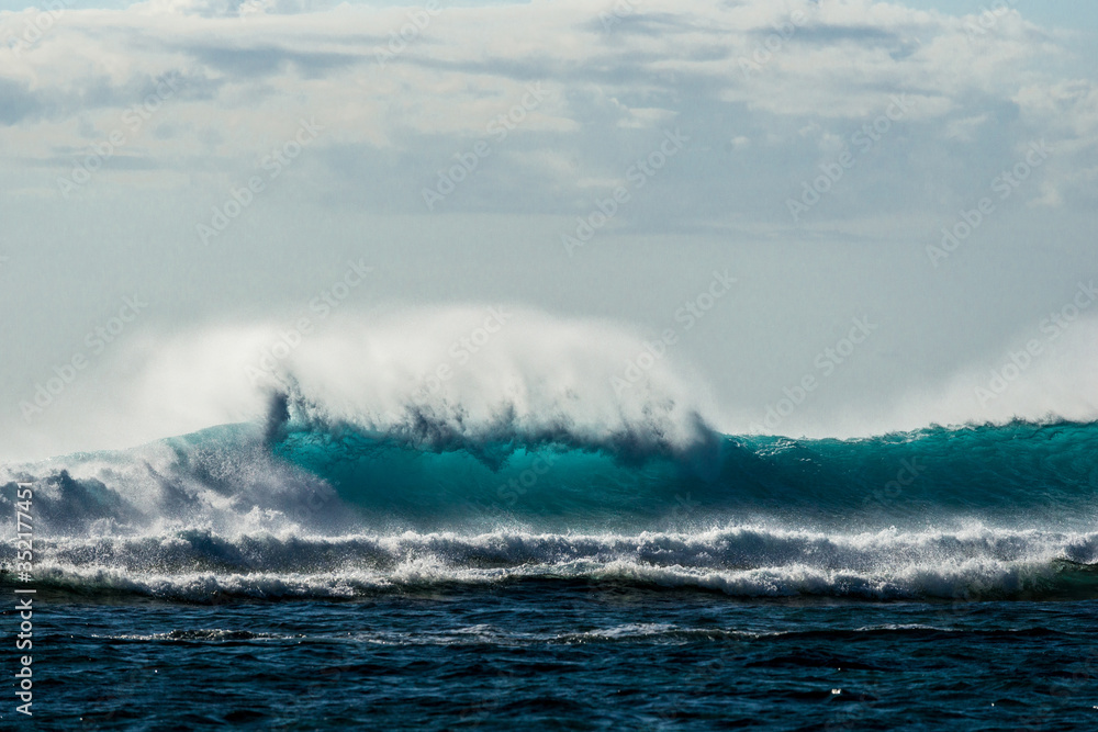 A huge wave for surfing . The photo was taken from the water in the Indian Ocean island of Mauritius A huge wave for surfing . The photo was taken from the water in the Indian Ocean island of Mauritius