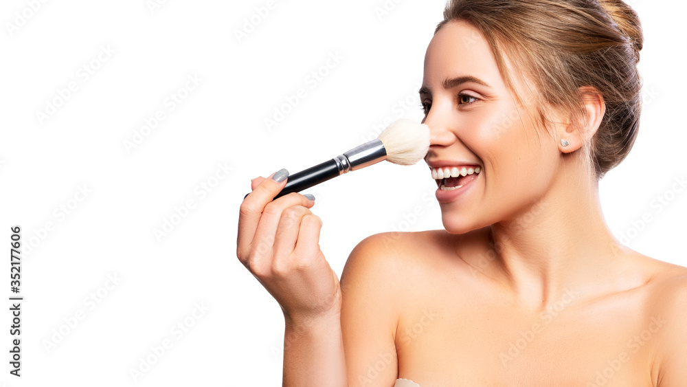 Close up of a brunette cute woman face with fresh clean flawless skin. She apply mascara on her face with a brush. Studio beauty portrait on white background Close up of a brunette cute woman face with fresh clean flawless skin. She apply mascara on her face with a brush. Studio beauty portrait on white background