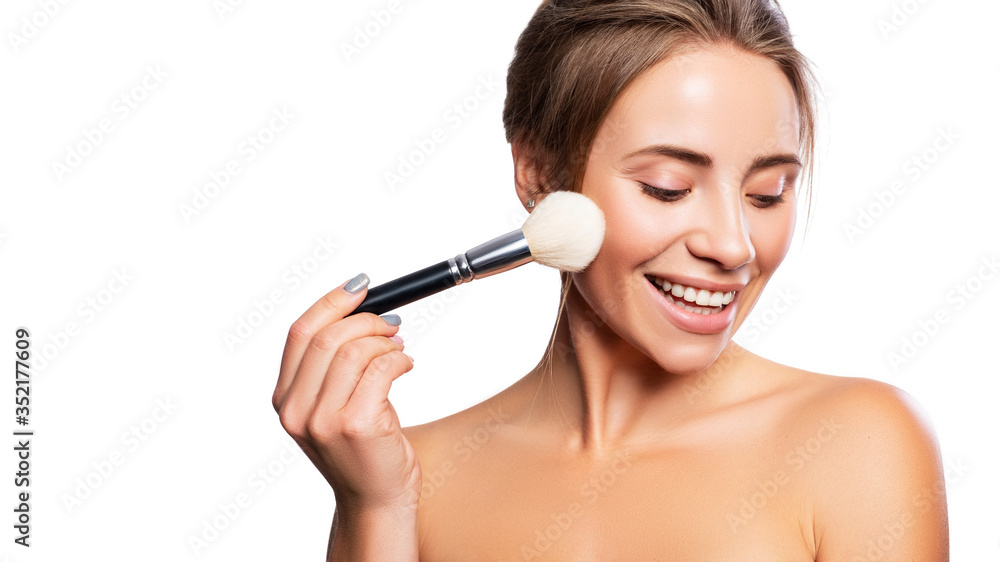 Close up of a brunette cute woman face with fresh clean flawless skin. She apply mascara on her face with a brush. Studio beauty portrait on white background Close up of a brunette cute woman face with fresh clean flawless skin. She apply mascara on her face with a brush. Studio beauty portrait on white background