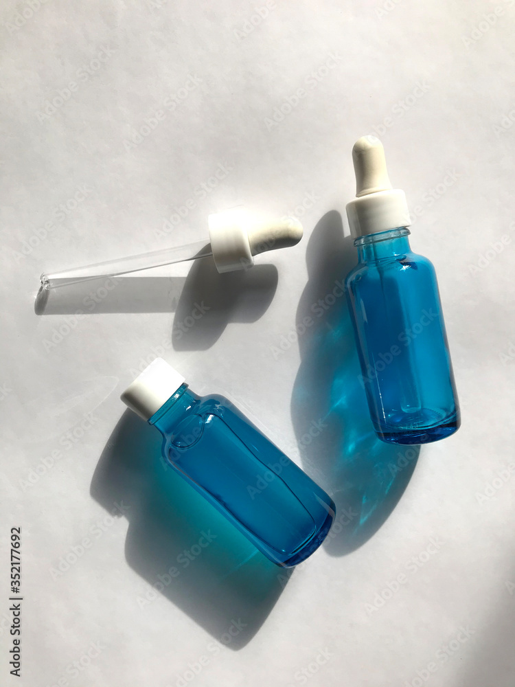 bubble with serum and a dropper in the sunlight. cosmetics for care bubble with serum and a dropper in the sunlight. cosmetics for care