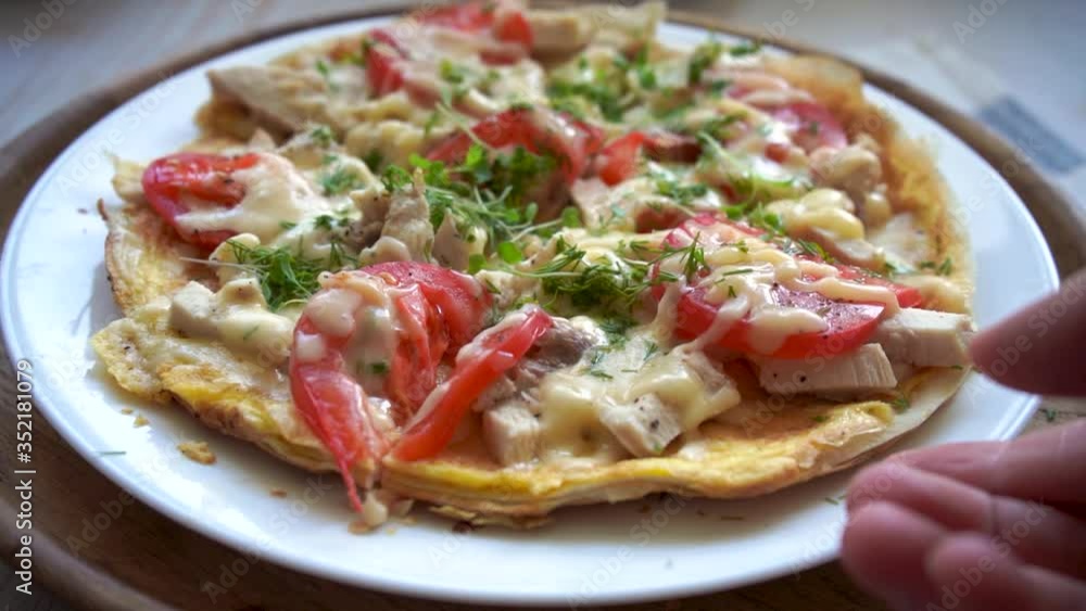 take a slice of pizza on a pita bread with chicken, tomatoes and stretching cheese take a slice of pizza on a pita bread with chicken, tomatoes and stretching cheese
