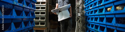 Widescreen image, delivery, a man in a warehouse carries a toilet in his hands