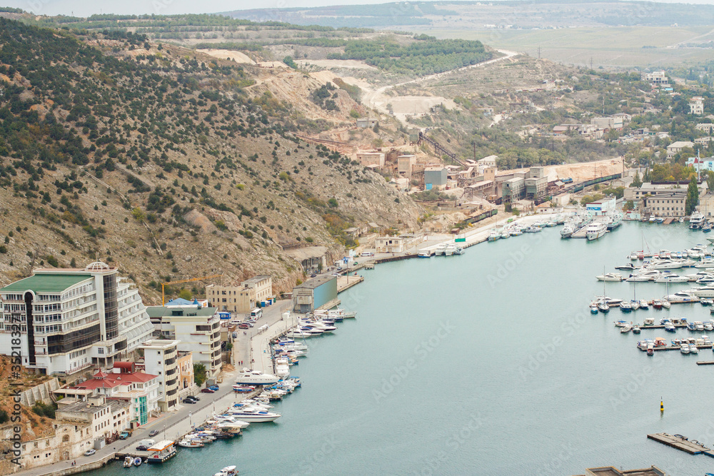 View on Balaklava bay, Crimea. Local tourism. liffs And Water. Seascape With Big Rocks. View on local port in Black Sea. Old Harbour With Fishing Boats. Yacht On The Marina Dock. pier for boats in bay