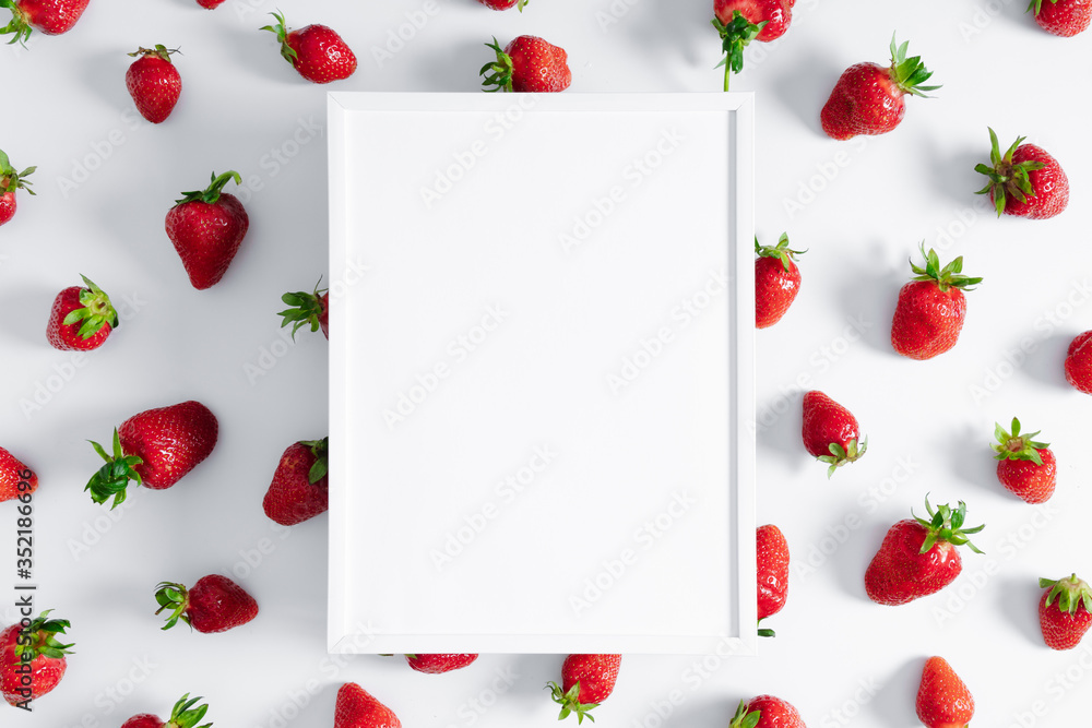 Strawberries berries pattern. Blank frame for text, strawberry on white background. Creative food concept. Flat lay, top view, copy space