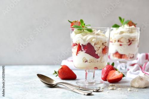 Eton mess - traditional english dessert with meringue, whipped cream and fresh berries. photo