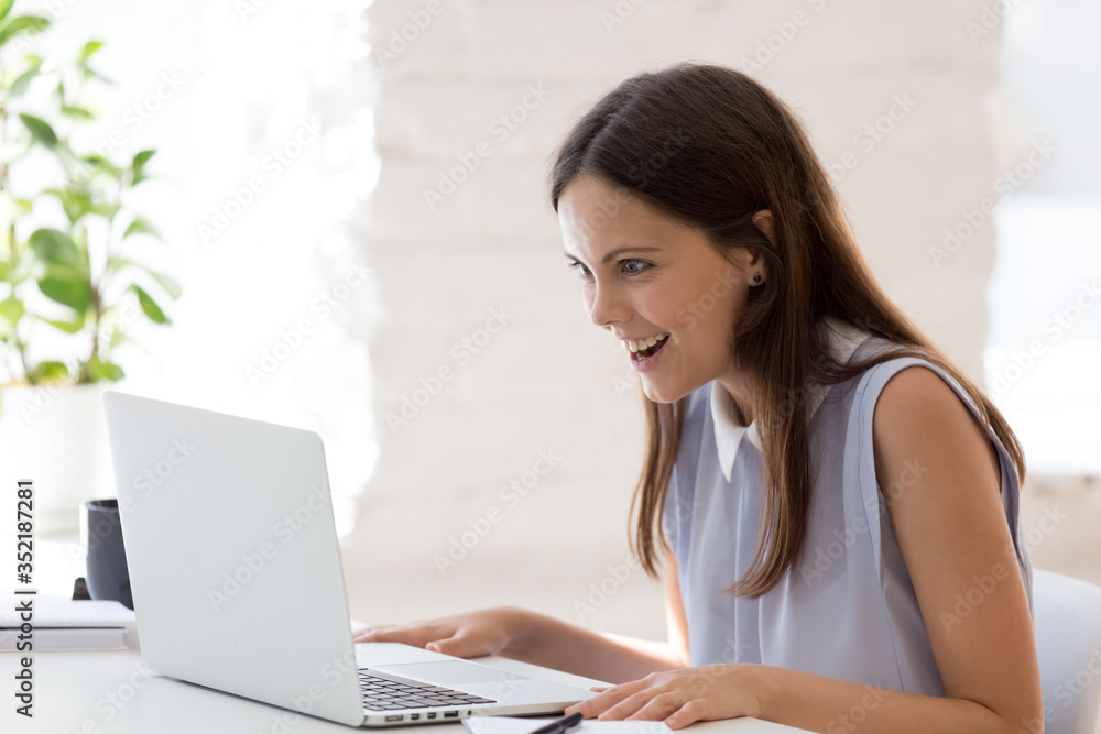 Surprised millennial female employee look at laptop screen stunned by unexpected work result, amazed woman worker shocked by unbelievable email or message on computer at workplace, luck concept Surprised millennial female employee look at laptop screen stunned by unexpected work result, amazed woman worker shocked by unbelievable email or message on computer at workplace, luck concept