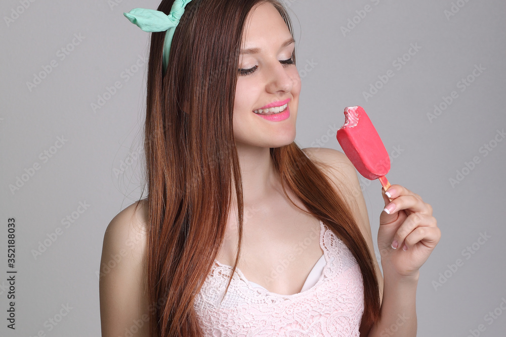 young beautiful woman eats icecream in studio young beautiful woman eats icecream in studio