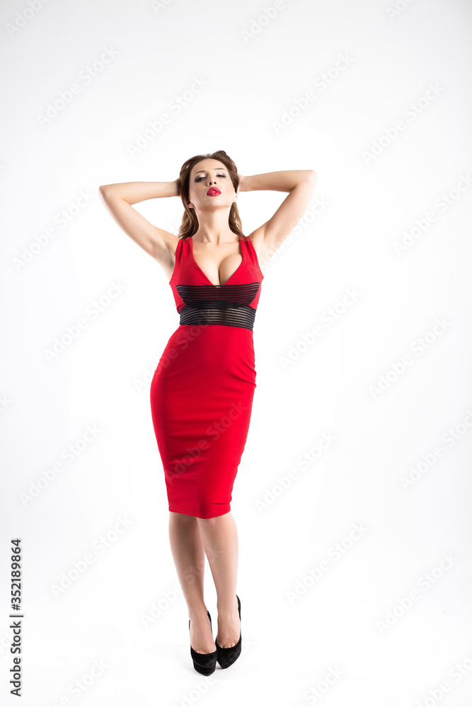 Beautiful attractive woman in a red dress in full length isolated.