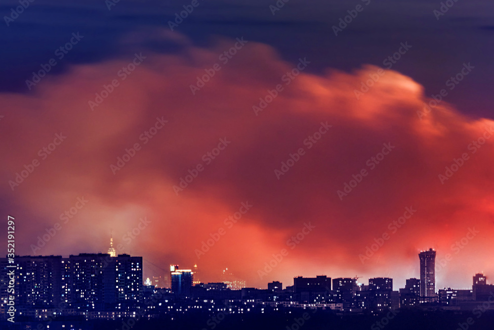Smoke and fire in residential area in Moscow city at night