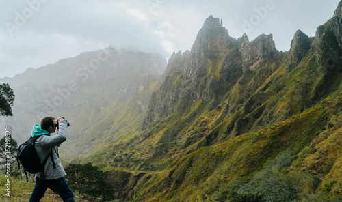 Man with camera taking a foto of gorgeous canyon valley on the path from Xo-Xo Valley. Santo Antao Island, Cape Verde © Igor Tichonow
