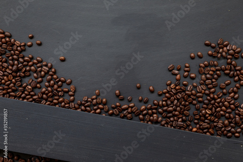 coffee bean on black wooden floor background. top view. space for text