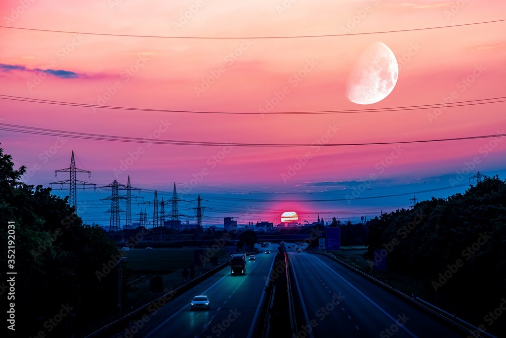 Sunset, moving cars with light turned on. Night scene on the highway