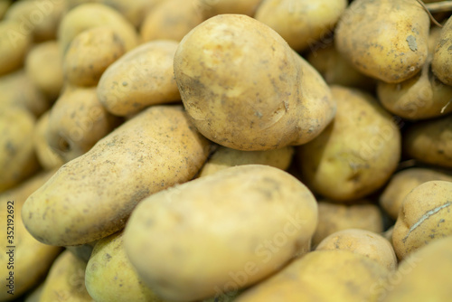 fresh potatoes standing at the market counter 
