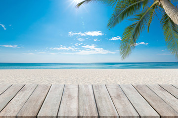 Wooden floor or plank on sand beach. For product display.Calm Sea and Blue Sky Background.tropical in summer.