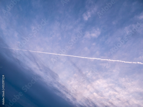 Trace of an airplane against blue sky