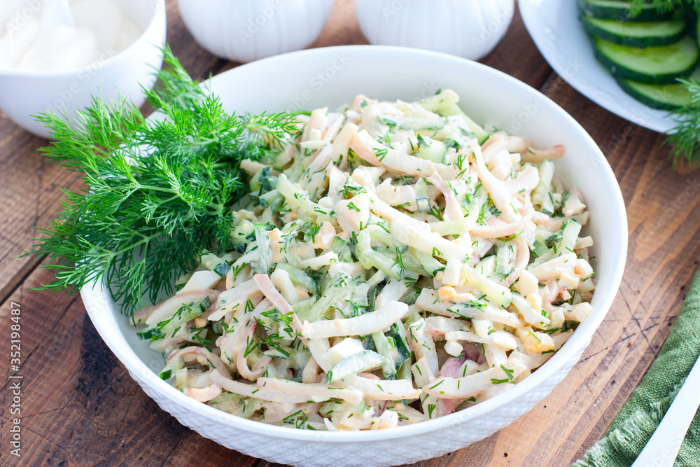 Salad with squid, eggs and fresh cucumbers, selective focus Salad with squid, eggs and fresh cucumbers, selective focus