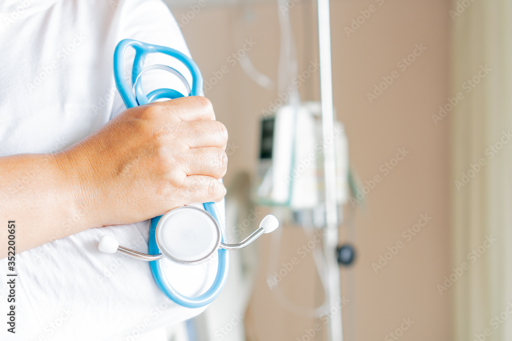 Fototapeta premium Doctor holding Stethoscope for checking treatment patient with saline drip medical, IV solution, Intravenous therapy for patient in hospital,Stethoscope is acoustic medical device for auscultation
