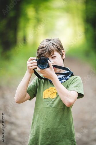 Young boy photographer with camera