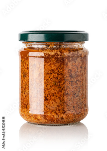 red basil pesto sauce in glass jar