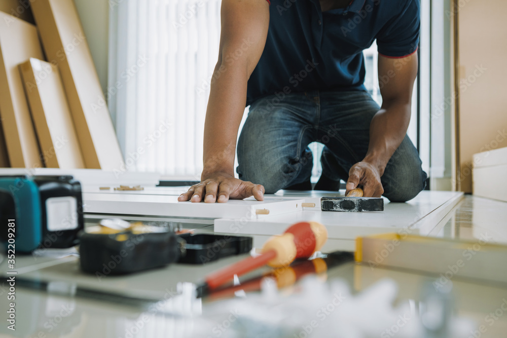Service man assembling furniture for customer, Delivery service furniture store and assembling for buyer. Service man assembling furniture for customer, Delivery service furniture store and assembling for buyer.
